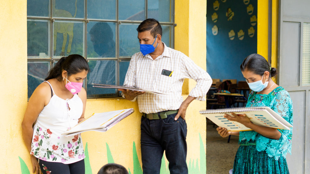 A PoP-supported teacher reads manuals/guides provided by PoP outside of classrooms.